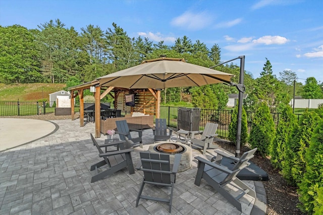 16 Daniels Dr, Lee, NH 03861 - fenced backyard featuring an outdoor fire pit, a patio, outdoor dining area, and a gazebo