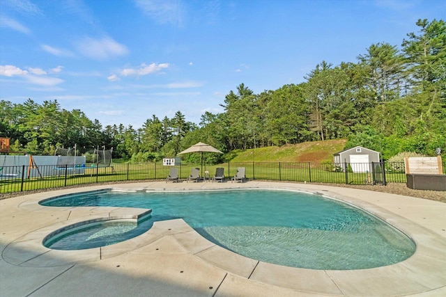 16 Daniels Dr, Lee, NH 03861 - view of swimming pool featuring a jacuzzi, a patio, and view of scattered trees