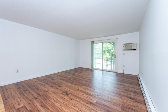 5 Autumn Leaf Dr Unit 24, Nashua, NH 03060 - spare room with a baseboard heating unit, a wall unit AC, and dark wood-type flooring