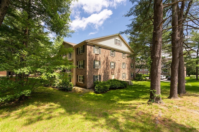 5 Autumn Leaf Dr Unit 24, Nashua, NH 03060 - view of home's exterior with brick siding and a yard