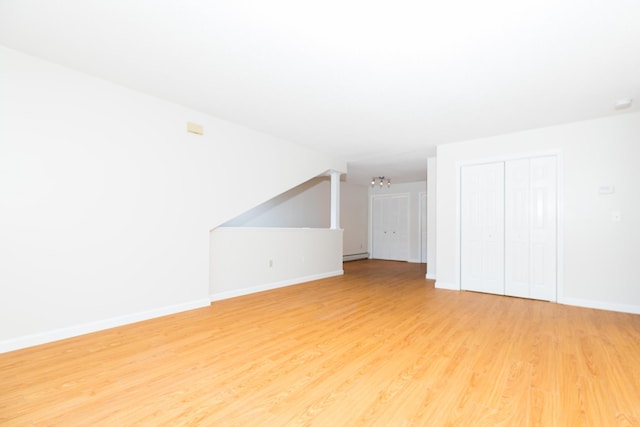 703 Springbrook Cir, Portsmouth, NH 03801 - bonus room with light wood-style flooring, a baseboard heating unit, and a chandelier