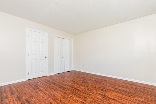 703 Springbrook Cir, Portsmouth, NH 03801 - unfurnished bedroom with wood finished floors and a closet