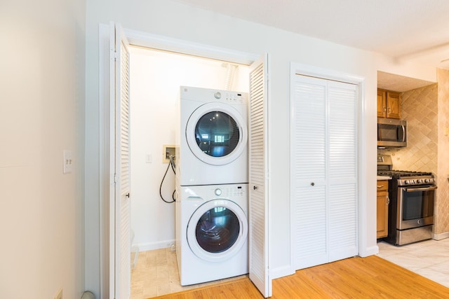 703 Springbrook Cir, Portsmouth, NH 03801 - laundry area with stacked washer and clothes dryer and light wood-style floors