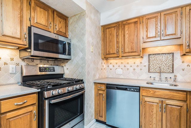 703 Springbrook Cir, Portsmouth, NH 03801 - kitchen with appliances with stainless steel finishes, light countertops, decorative backsplash, and brown cabinets