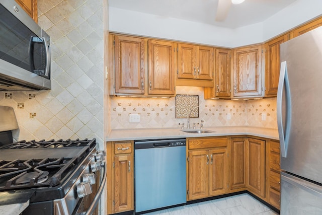 703 Springbrook Cir, Portsmouth, NH 03801 - kitchen with appliances with stainless steel finishes, light countertops, backsplash, and brown cabinets