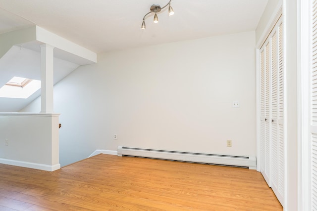 703 Springbrook Cir, Portsmouth, NH 03801 - bonus room with a baseboard heating unit, light wood-type flooring, and a skylight