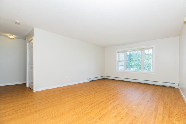 703 Springbrook Cir, Portsmouth, NH 03801 - empty room with light wood-style flooring, a baseboard radiator, and a smoke detector