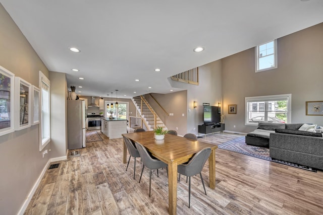 86 Chestnut St, Claremont, NH 03743 - dining area with stairs, light wood-style floors, plenty of natural light, and recessed lighting