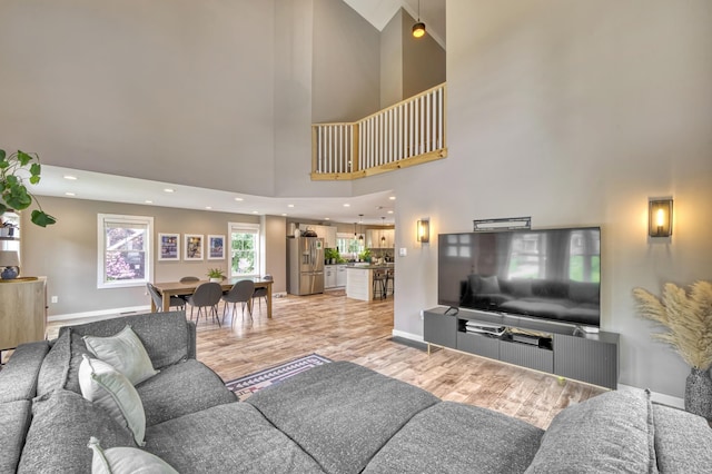 86 Chestnut St, Claremont, NH 03743 - living room featuring a towering ceiling and light wood finished floors