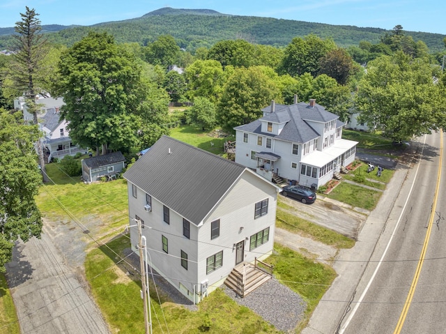 86 Chestnut St, Claremont, NH 03743 - aerial view of property and surrounding area with a heavily wooded area and a mountain backdrop