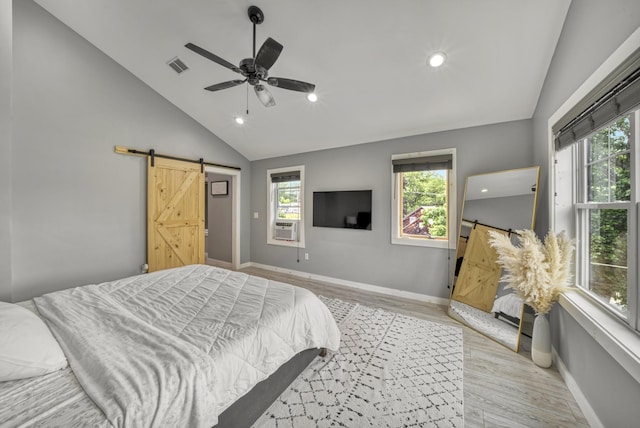 86 Chestnut St, Claremont, NH 03743 - bedroom with a barn door, light wood-style floors, recessed lighting, a ceiling fan, and high vaulted ceiling