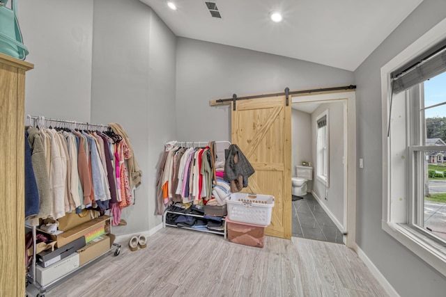 86 Chestnut St, Claremont, NH 03743 - walk in closet with vaulted ceiling, wood finished floors, and a barn door