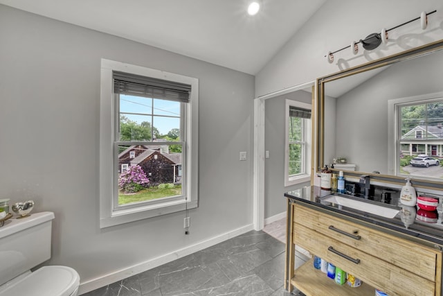 86 Chestnut St, Claremont, NH 03743 - bathroom with healthy amount of natural light, vaulted ceiling, vanity, and marble look tile flooring