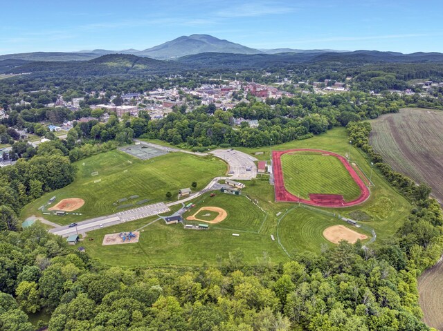 86 Chestnut St, Claremont, NH 03743 - aerial view of property and surrounding area featuring a mountain backdrop