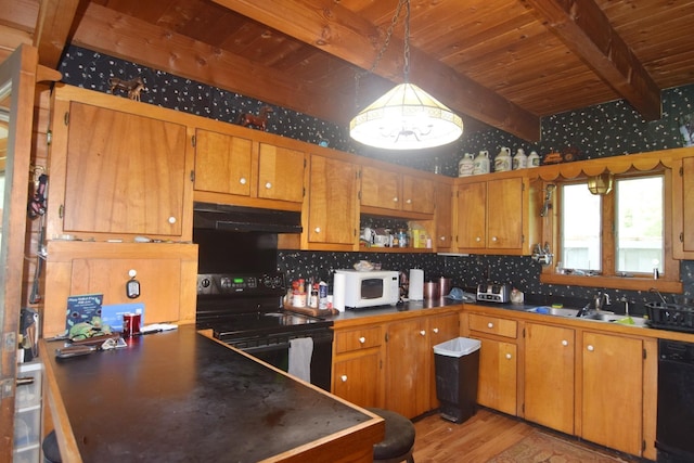 2054 Whitefield Rd, Bethlehem, NH 03574 - kitchen with black appliances, under cabinet range hood, a wooden ceiling with exposed beams, and brown cabinets