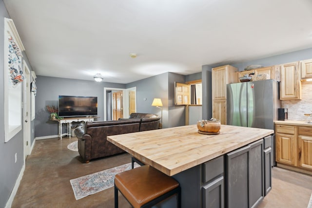 153 May St, Canaan, NH 03741 - kitchen with butcher block countertops, freestanding refrigerator, finished concrete flooring, decorative backsplash, and open floor plan