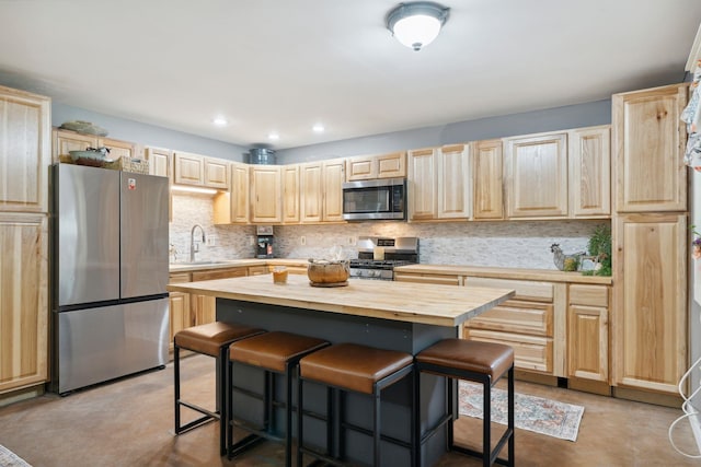 153 May St, Canaan, NH 03741 - kitchen featuring stainless steel appliances, light brown cabinetry, a kitchen bar, butcher block counters, and recessed lighting