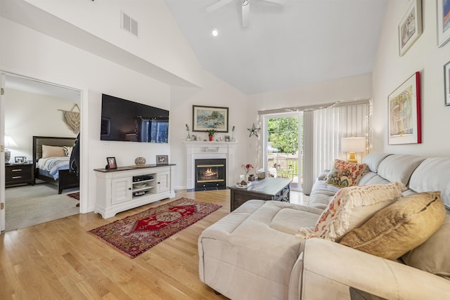 34 Mammoth Rd Unit 1, Hooksett, NH 03106 - living room featuring a ceiling fan, high vaulted ceiling, wood finished floors, and a fireplace with flush hearth