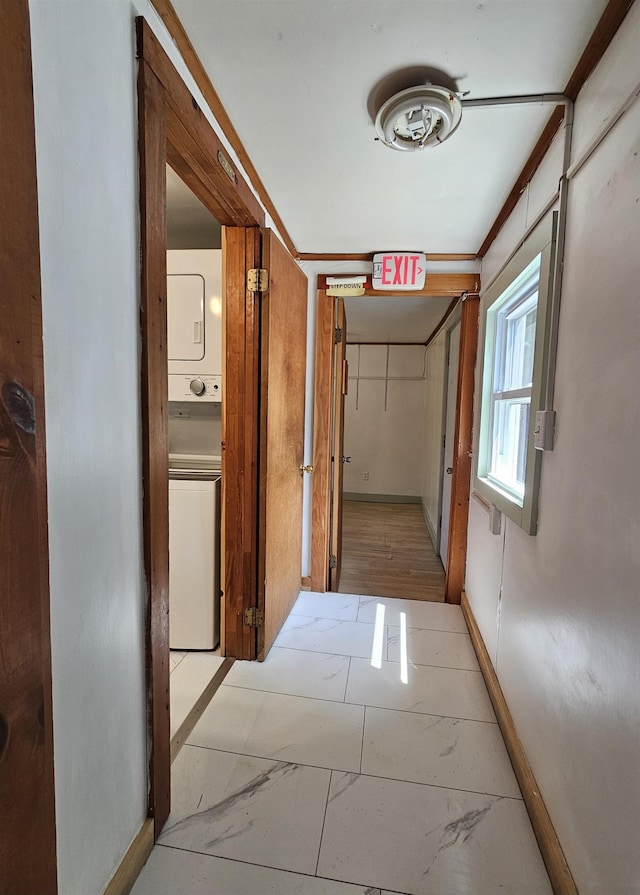 42 Upper Knight St, Keene, NH 03431 - hall with stacked washer and clothes dryer and light marble finish flooring