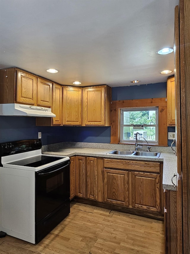 42 Upper Knight St, Keene, NH 03431 - kitchen featuring black electric range oven, under cabinet range hood, light wood-type flooring, brown cabinetry, and recessed lighting