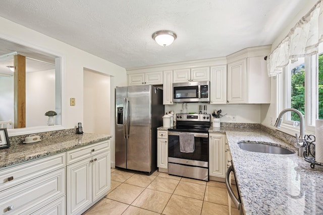 20 Meadow Ln, Atkinson, NH 03811 - kitchen featuring appliances with stainless steel finishes, light stone counters, light tile patterned flooring, and white cabinets