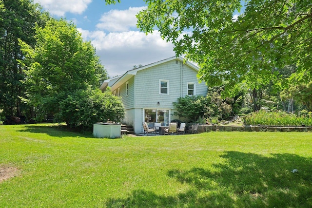 20 Meadow Ln, Atkinson, NH 03811 - rear view of property with a lawn and a patio