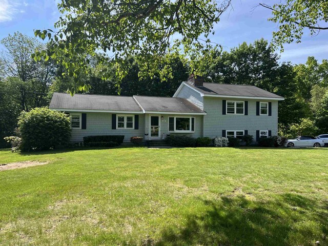 20 Meadow Ln, Atkinson, NH 03811 - tri-level home with a front yard and a chimney