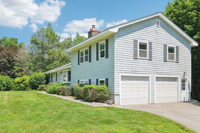 20 Meadow Ln, Atkinson, NH 03811 - view of property exterior featuring a chimney, a garage, asphalt driveway, and a lawn