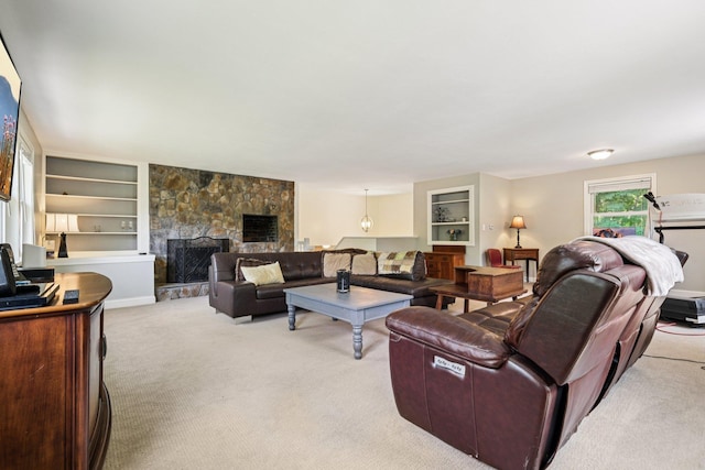 20 Meadow Ln, Atkinson, NH 03811 - living area with light colored carpet, a stone fireplace, and built in shelves