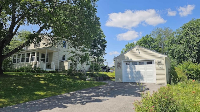 18 Cross St, Allenstown, NH 03275 - view of property exterior featuring asphalt driveway, a garage, a lawn, and an outbuilding