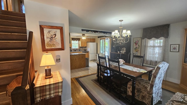 18 Cross St, Allenstown, NH 03275 - dining area with a chandelier, stairs, and light wood-style flooring