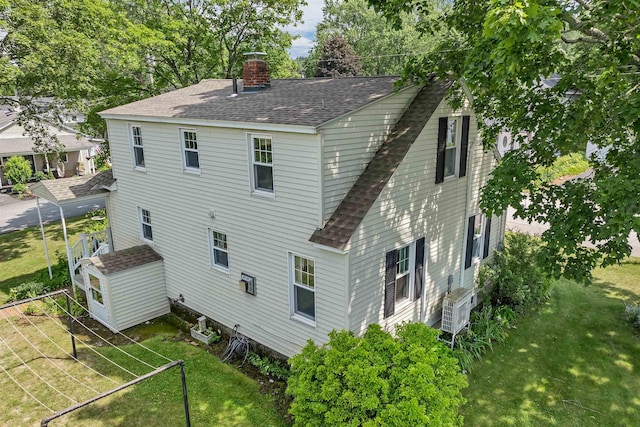 18 Cross St, Allenstown, NH 03275 - rear view of property featuring roof with shingles, a chimney, and a yard