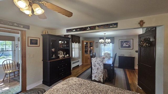 18 Cross St, Allenstown, NH 03275 - dining room featuring radiator heating unit, a chandelier, ceiling fan, and dark wood finished floors