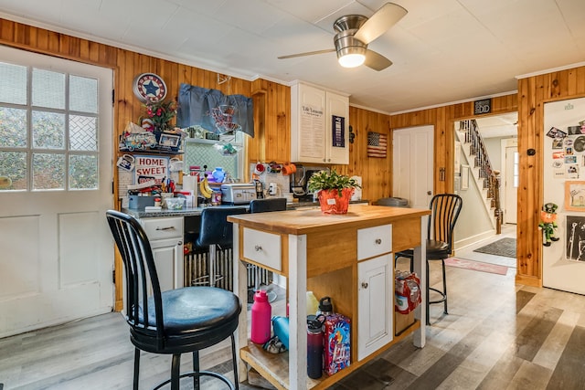 8 Myrtle St, Somersworth, NH 03878 - kitchen featuring butcher block counters, crown molding, ceiling fan, wood walls, and freestanding refrigerator