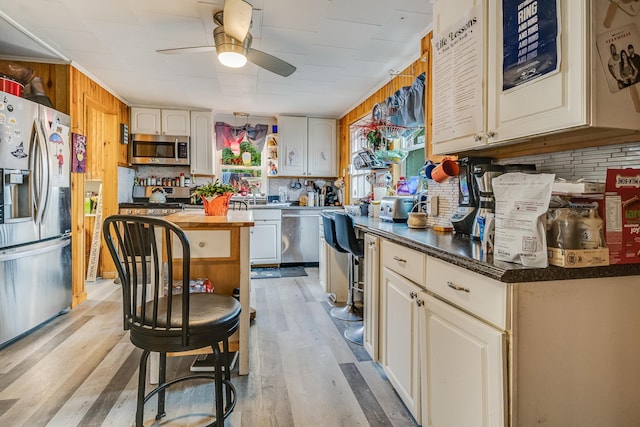 8 Myrtle St, Somersworth, NH 03878 - kitchen featuring appliances with stainless steel finishes, ceiling fan, light wood-style floors, and cream cabinetry