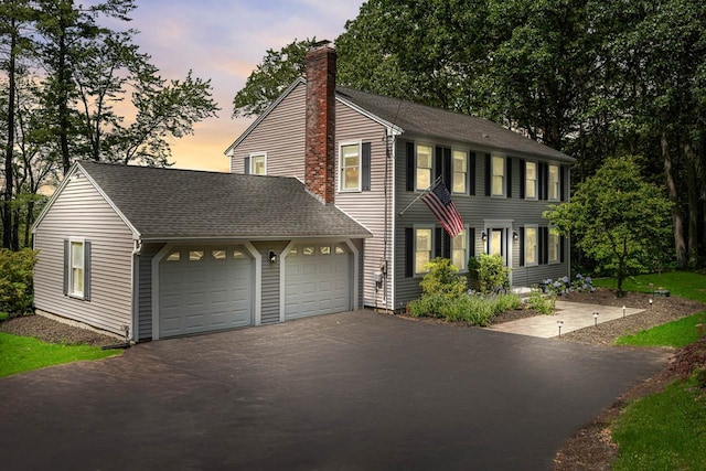 7 Dearborn Ln, Bedford, NH 03110 - colonial home featuring driveway, a chimney, a garage, and a shingled roof