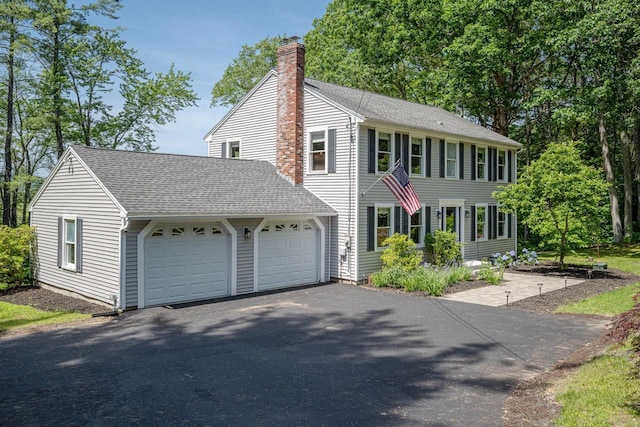 7 Dearborn Ln, Bedford, NH 03110 - colonial home with a chimney, driveway, roof with shingles, and a garage