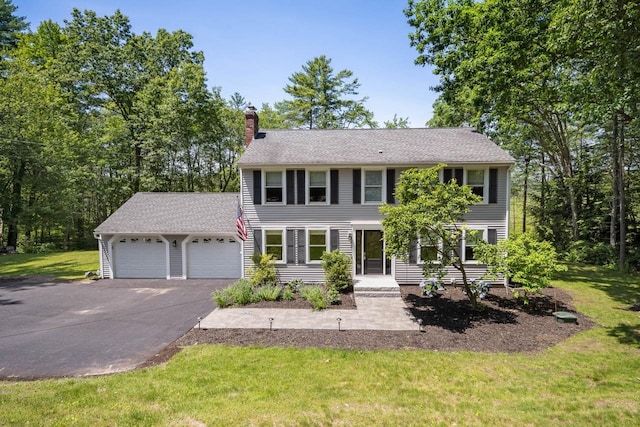 7 Dearborn Ln, Bedford, NH 03110 - colonial house featuring a chimney, a garage, driveway, and a front yard