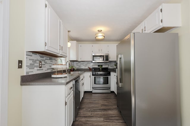 38 Brook Hollow Way, Manchester, NH 03103 - kitchen featuring appliances with stainless steel finishes, dark countertops, and white cabinetry