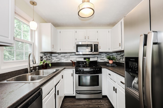 38 Brook Hollow Way, Manchester, NH 03103 - kitchen featuring appliances with stainless steel finishes, white cabinetry, dark countertops, and dark wood-style floors