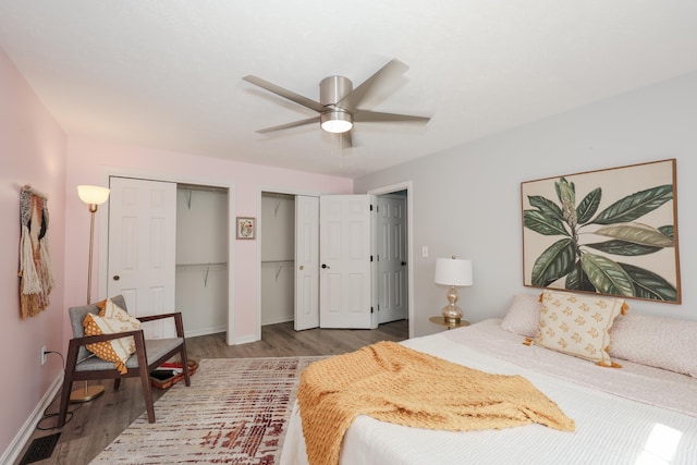 38 Brook Hollow Way, Manchester, NH 03103 - bedroom featuring multiple closets, wood finished floors, and a ceiling fan