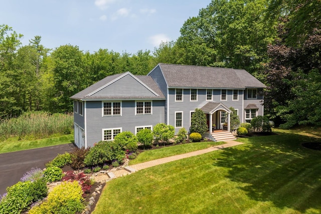 23 Rockrimmon Rd, North Hampton, NH 03862 - colonial inspired home featuring an attached garage, a front yard, driveway, and a shingled roof