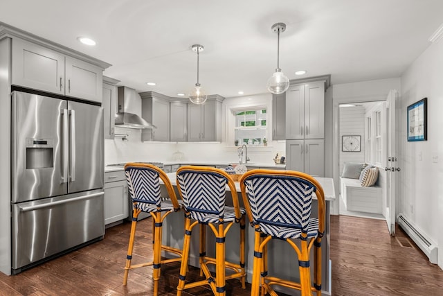 23 Rockrimmon Rd, North Hampton, NH 03862 - kitchen featuring stainless steel fridge with ice dispenser, wall chimney range hood, gray cabinets, a baseboard radiator, and dark wood-style flooring
