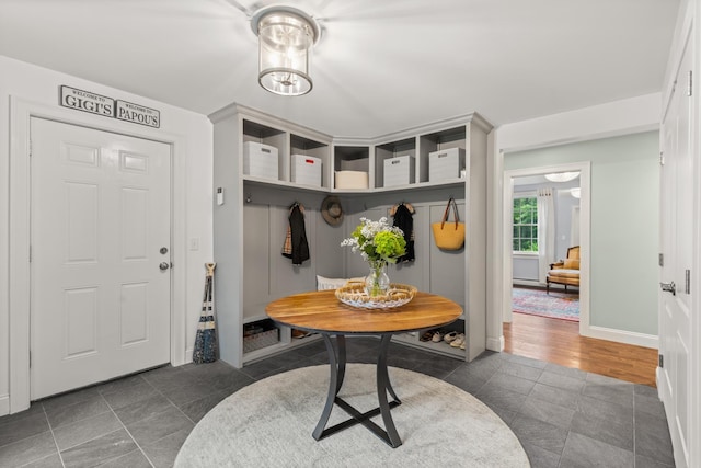 23 Rockrimmon Rd, North Hampton, NH 03862 - mudroom featuring dark tile patterned floors and baseboards