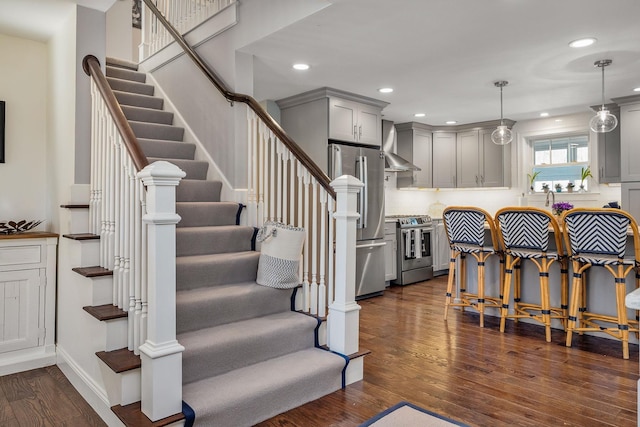 23 Rockrimmon Rd, North Hampton, NH 03862 - kitchen with appliances with stainless steel finishes, gray cabinetry, wall chimney exhaust hood, dark wood-style floors, and recessed lighting