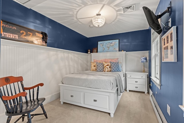 23 Rockrimmon Rd, North Hampton, NH 03862 - bedroom with light colored carpet, a wainscoted wall, and a baseboard radiator