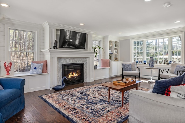 23 Rockrimmon Rd, North Hampton, NH 03862 - living room with a large fireplace, dark wood-type flooring, healthy amount of natural light, ornamental molding, and recessed lighting