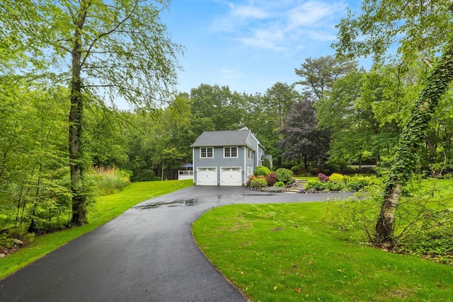 23 Rockrimmon Rd, North Hampton, NH 03862 - view of front of home featuring asphalt driveway, an attached garage, a front yard, and a view of trees