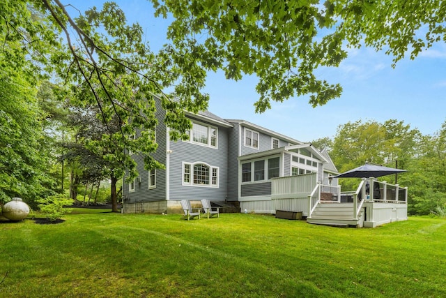 23 Rockrimmon Rd, North Hampton, NH 03862 - back of property featuring a lawn, a wooden deck, and a sunroom
