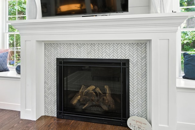 23 Rockrimmon Rd, North Hampton, NH 03862 - detailed view of a tiled fireplace and wood finished floors